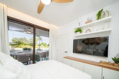 a bedroom with a bed and a dining room at Aqua Luxe Opulence Vista Piscina & Golf · by Sun5 in Punta Cana