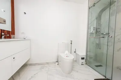 a bathroom with a toilet and a glass shower at Luxury 2BR, Private Jacuzzi, CanaRock Star in Punta Cana