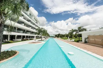 a large swimming pool in front of a building at Luxury 2BR, Private Jacuzzi, CanaRock Star in Punta Cana