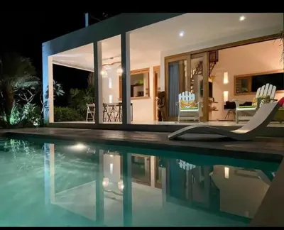 a villa with a swimming pool at night at Villa Leon Azul in La Iglesia