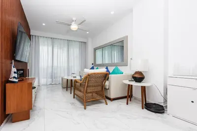 a living room with a table and a dining room at Luxury 2BR Private Jacuzzi CanaRock Star Punta Cana in Punta Cana