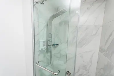 a shower with a glass door in a bathroom at Luxury 2BR Private Jacuzzi CanaRock Star Punta Cana in Punta Cana