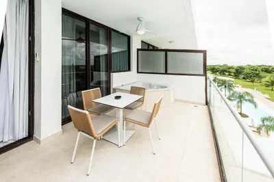 a dining room with a table and chairs on a balcony at Luxury 2BR Private Jacuzzi CanaRock Star Punta Cana in Punta Cana
