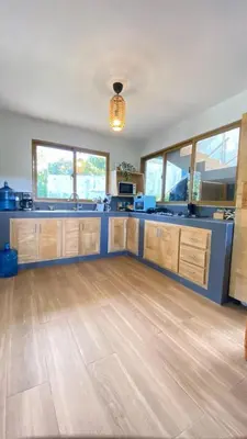 a large kitchen with wooden cabinets and blue counter tops at Villa Mis Núñez