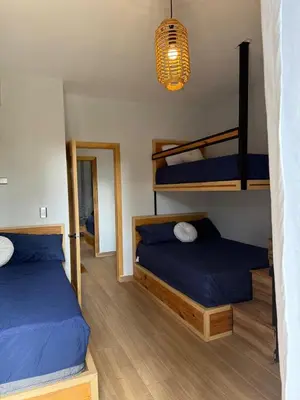 a bedroom with two bunk beds and a mirror at Villa Mis Núñez