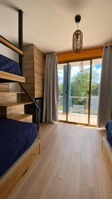 a bedroom with a bunk bed and a large window at Villa Mis Núñez