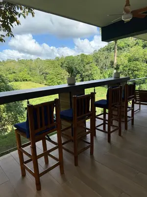 a porch with chairs and a bar with a view at Villa Mis Núñez