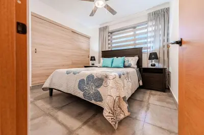a bedroom with a bed and a ceiling fan at Villa Sunrise an elegant private villa in Central Sosua in Sosúa