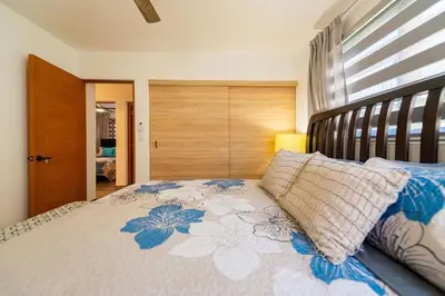 a bedroom with a large bed with blue flowers on it at Villa Sunrise an elegant private villa in Central Sosua in Sosúa