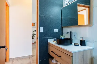 a bathroom with a sink and a mirror at Villa Sunrise an elegant private villa in Central Sosua in Sosúa