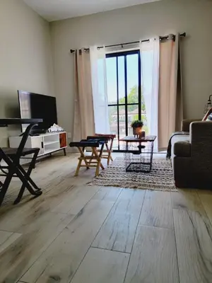 a living room with a couch and a table at Encuentro Vaquero in Jarabacoa
