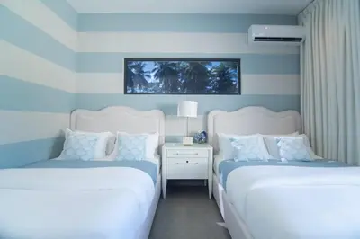 two beds in a bedroom with blue and white walls at Playa Bonita Fully Serviced Villa - Walk to Beach in Las Terrenas