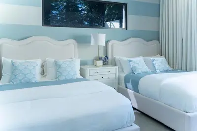 two beds in a bedroom with blue walls at Playa Bonita Fully Serviced Villa - Walk to Beach in Las Terrenas