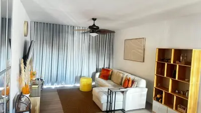 a living room with a white couch and a window at Beautiful apartment Bavaro Beach in Punta Cana