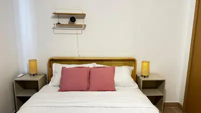 a bedroom with a bed with two pink pillows at Beautiful apartment Bavaro Beach in Punta Cana