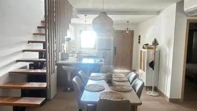 a dining room and kitchen with a table and chairs at Beautiful apartment Bavaro Beach in Punta Cana