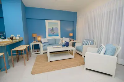a living room with a couch and a table at Stunning Beachfront 2BR Condo in Juan Dolio in Juan Dolio