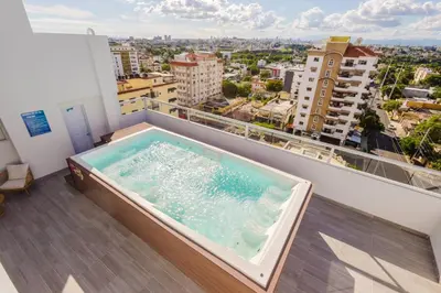 a hot tub on the balcony of a building at Cozy 3BR Condo in Ens. Ozama in La Cruz de Mendoza