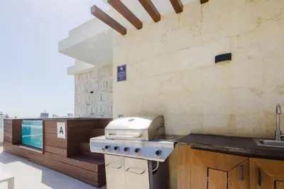 a kitchen with a stove and a sink at Luxury City Center Condo, Roof Top Jacuzzi in Santo Domingo