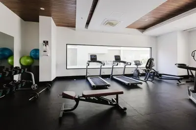 a gym with several exercise bikes in a room at Luxury City Center Condo, Roof Top Jacuzzi in Santo Domingo