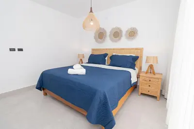 a bedroom with a blue bed and a night stand at Elegant 1-BD Luxury Escape in Paradise in Estrella
