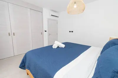 a bedroom with a blue and white bed with a towel on it at Elegant 1-BD Luxury Escape in Paradise in Estrella