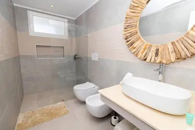 a bathroom with a sink and a toilet and a mirror at Elegant 1-BD Luxury Escape in Paradise in Estrella