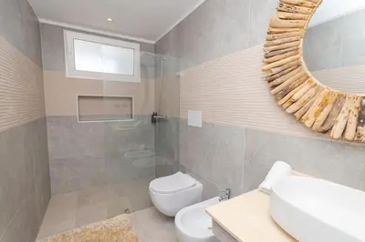 a bathroom with a sink toilet and a mirror at Elegant 1-BD Luxury Escape in Paradise in Estrella