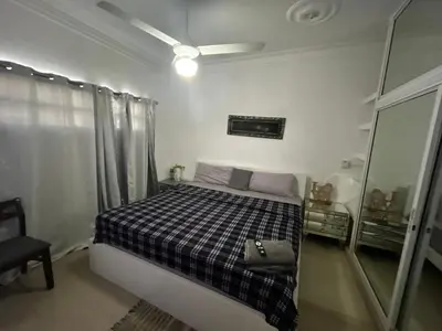 a small bedroom with a bed and a mirror at Casa Villa para grupos grandes in Ciruelitos Arriba