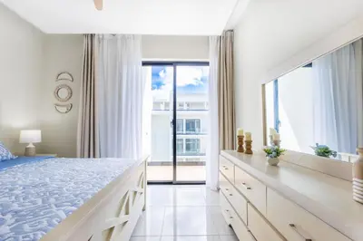 a bedroom with a large bed and a large window at Stylish 1BR Apartment Near Bávaro Beach, Pool View in Punta Cana