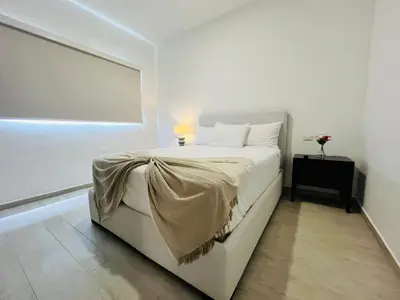 a white bedroom with a white bed and a window at Cana Pearl in Punta Cana