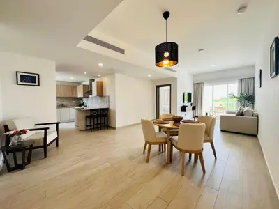 a living room and dining room with a table and chairs at Cana Pearl in Punta Cana