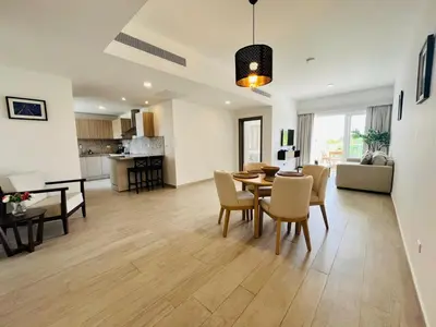 a living room and dining room with a table and chairs at Cana Pearl in Punta Cana