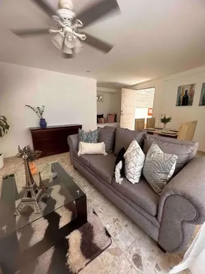 a living room with a couch and a ceiling fan at Puerto Plata, beach Pent house in Maggiolo