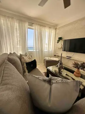 a living room with a couch and a tv at Puerto Plata, beach Pent house in Maggiolo