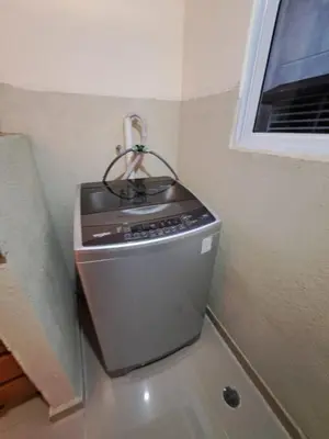 a kitchen with a stove in the corner of a room at Luxurious and comfortable in the safest area in Juan López