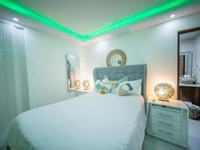 a bedroom with a white bed with a green ceiling at Room in Sosua With Nice Jacuzzi in Sosúa