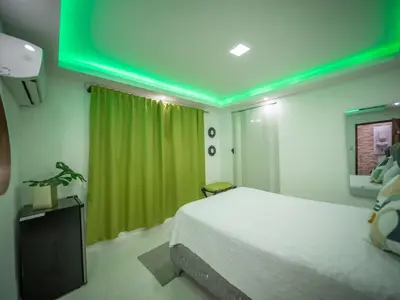 a bedroom with a bed and a green ceiling at Room in Sosua With Nice Jacuzzi in Sosúa