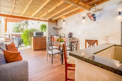 a kitchen and living room with a table and chairs at Room in Sosua With Nice Jacuzzi in Sosúa