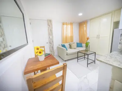 a living room with a couch and a table at Studio In Sosua Center Strip Zone in Sosúa