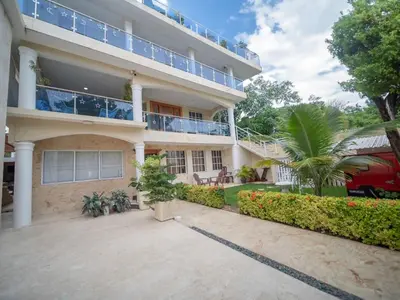an exterior view of a building with a patio at Studio In Sosua Center Strip Zone in Sosúa