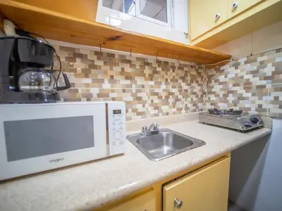 a kitchen with a sink and a microwave at Studio in Sosua Center Near Sosua beach in Sosúa