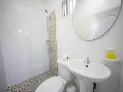 a bathroom with a toilet and a sink and a mirror at Studio in Sosua Center Near Sosua beach in Sosúa