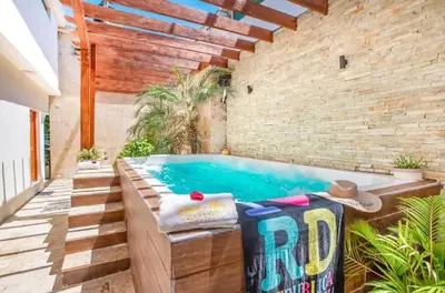 an outdoor swimming pool with a brick wall at Spacious 1BR APT in Sosua strip in Sosúa