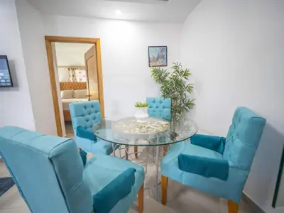 a dining room with blue chairs and a glass table at Cozy & Quiet 1BT Apt Central in Sosua in Sosúa
