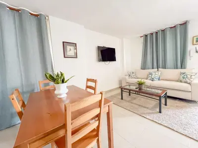 a living room with a table and a couch at Secure and Central 2BR Apt in Sosúa