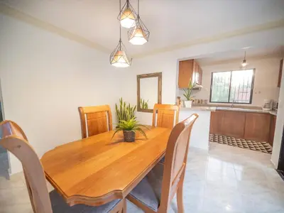 a dining room with a wooden table and chairs at Affordable 2BR APT in Sosua Center in Sosúa