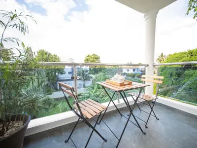 a balcony with a table and chairs on a balcony at 2BR APT in Sosua Center Strip zone in Sosúa