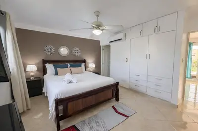 a bedroom with a bed and a ceiling fan at Garden Condos APT 35 - Affordable 1BR APT in Sosua in Sosúa