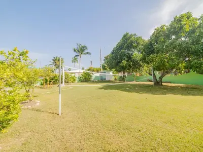 a park with a basketball hoop in the grass at COZY 7BR Villa BIG POOL Close to beach in Sosúa